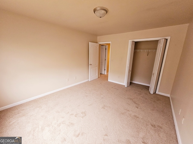 unfurnished bedroom featuring a closet and carpet flooring