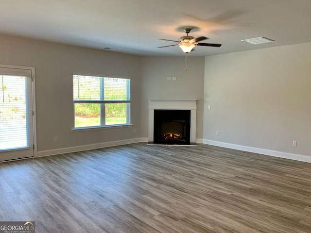 unfurnished living room with ceiling fan and wood-type flooring