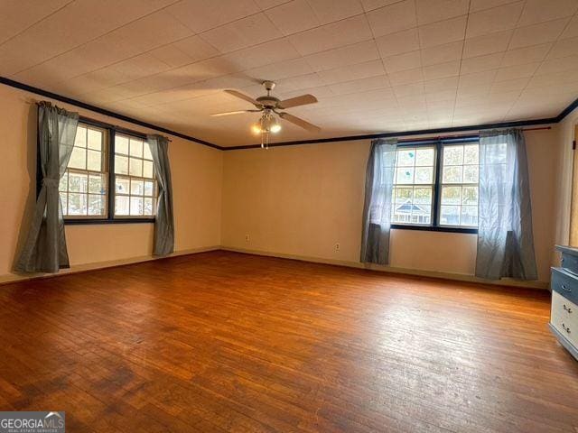 unfurnished room with hardwood / wood-style flooring, ceiling fan, and crown molding