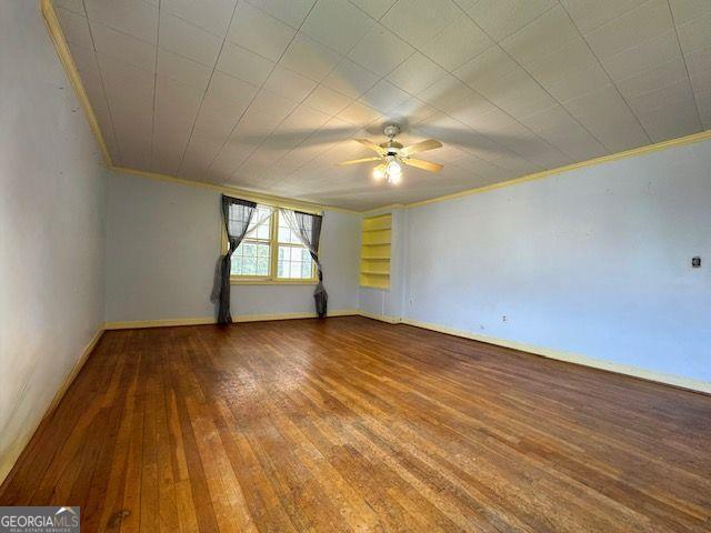 spare room featuring ceiling fan, crown molding, and hardwood / wood-style flooring