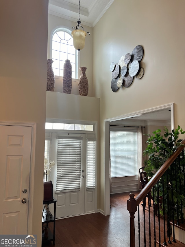 entryway featuring ornamental molding and dark hardwood / wood-style floors