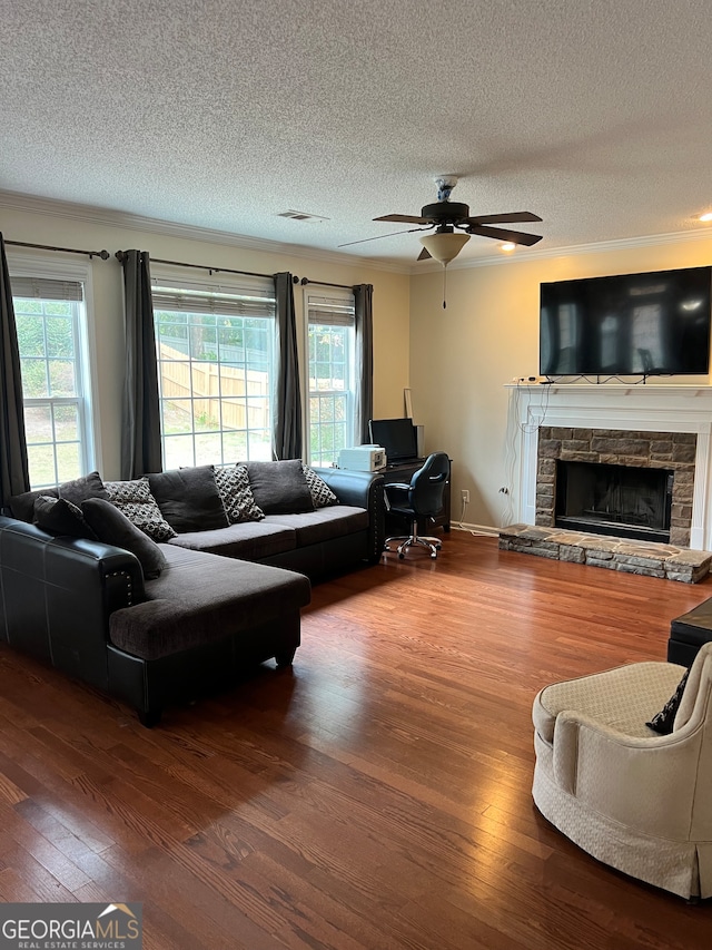 living room with hardwood / wood-style floors, a textured ceiling, and plenty of natural light