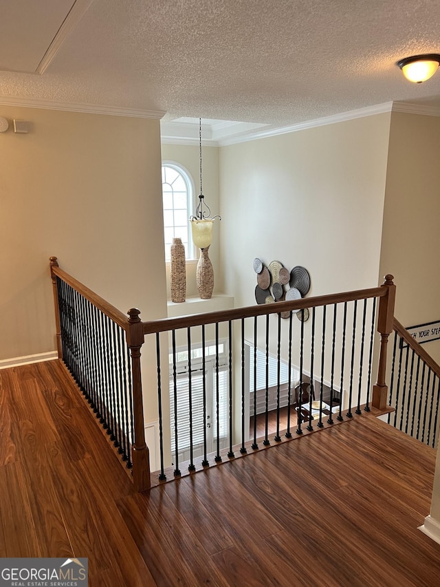 165 Summit Point Dr, Fayetteville, GA 30214 - staircase featuring wood finished floors, a textured ceiling, attic access, and ornamental molding