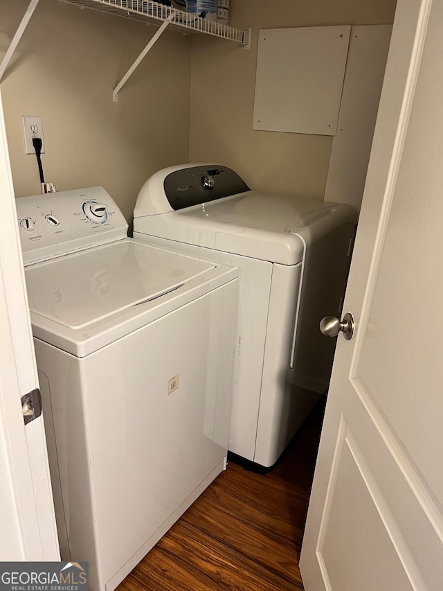 laundry room with dark hardwood / wood-style flooring and washing machine and clothes dryer