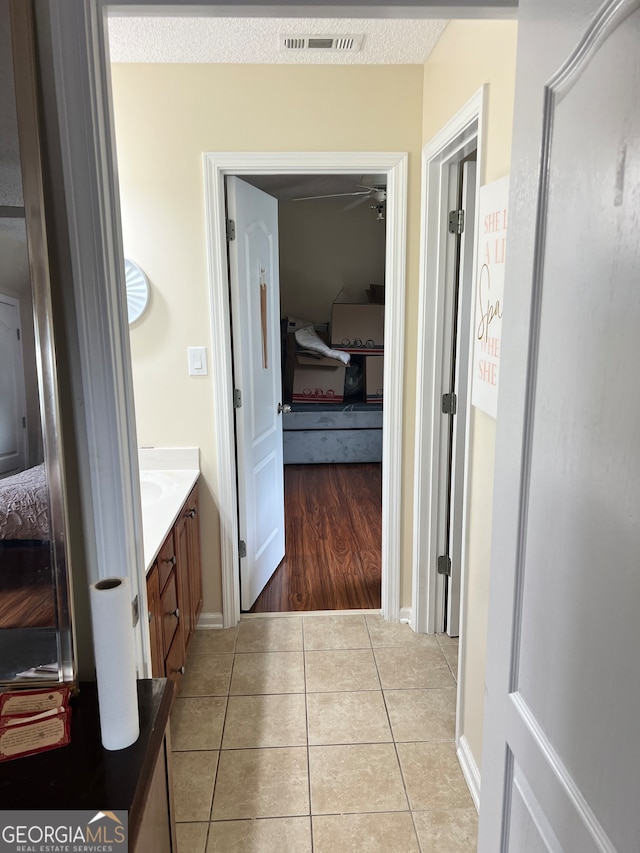 corridor featuring light tile patterned floors