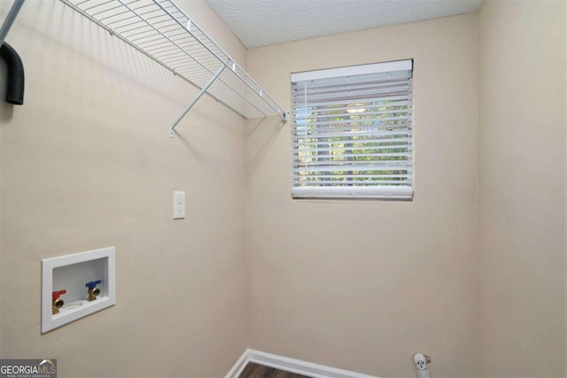 laundry area with hardwood / wood-style floors and hookup for a washing machine