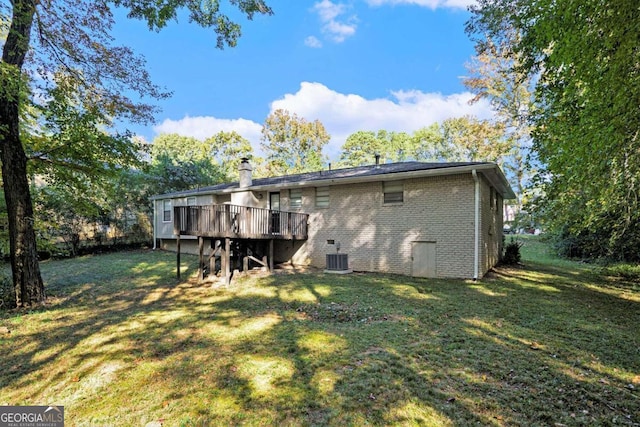 3881 Nations Dr, Douglasville, GA 30135 - back of property with a wooden deck, a yard, brick siding, and a chimney