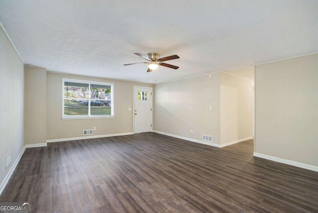 spare room featuring a textured ceiling, ceiling fan, and dark hardwood / wood-style flooring