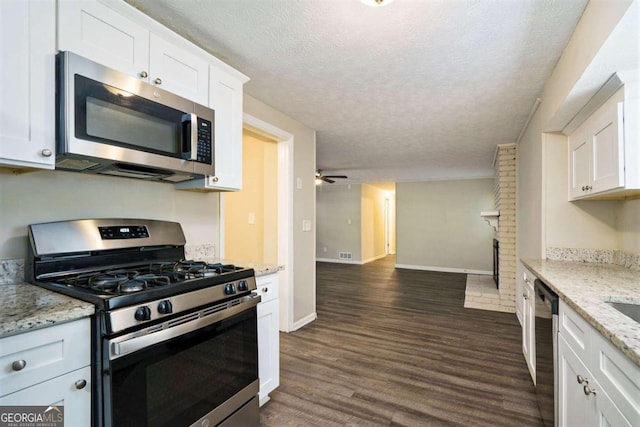 kitchen featuring white cabinetry, a textured ceiling, appliances with stainless steel finishes, and dark hardwood / wood-style flooring