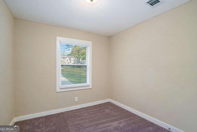 3881 Nations Dr, Douglasville, GA 30135 - spare room with baseboards and dark colored carpet