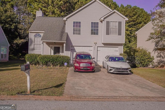 view of front of house with a front lawn and a garage