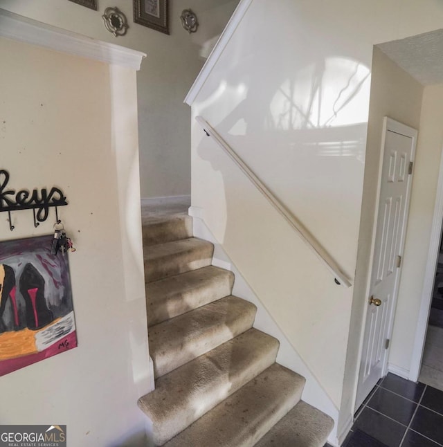 staircase featuring tile patterned flooring