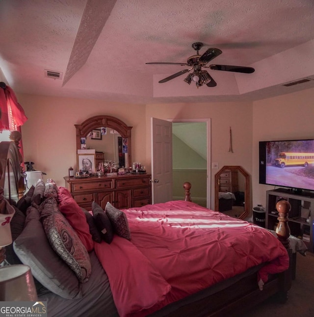 bedroom with a textured ceiling and ceiling fan