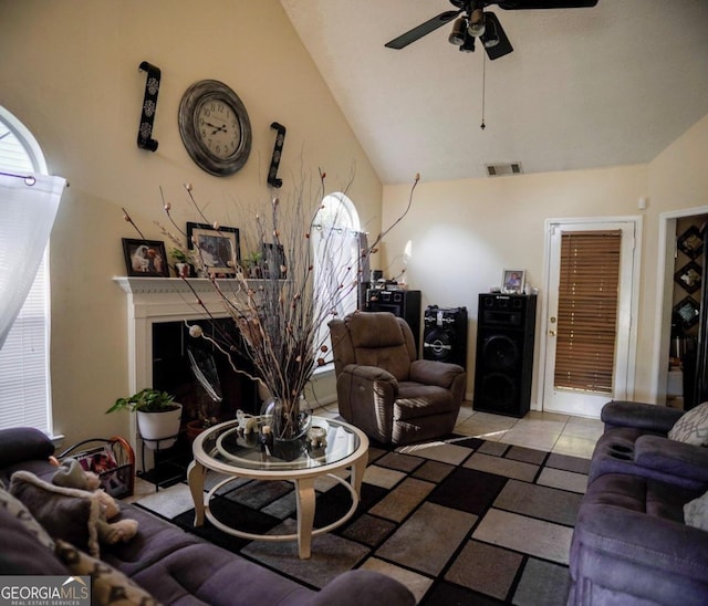 living room featuring ceiling fan and vaulted ceiling