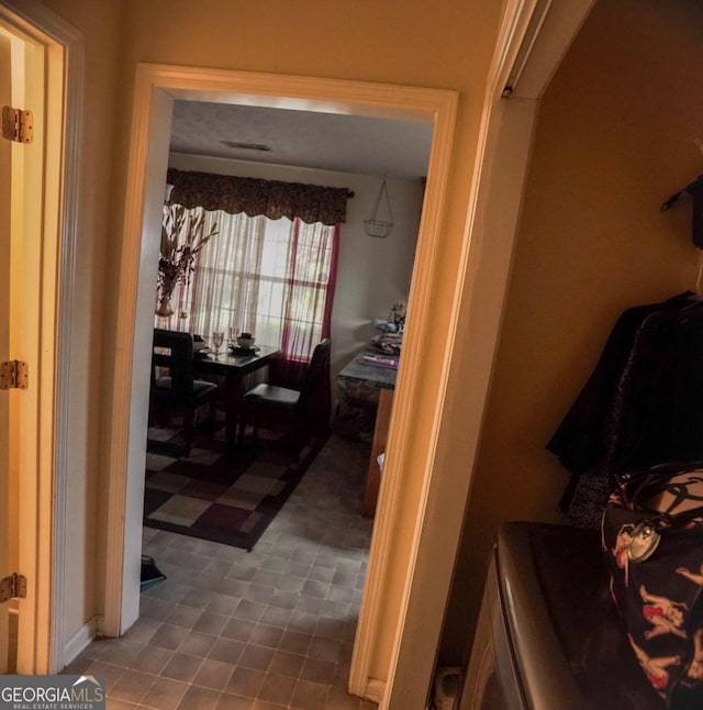 hallway with tile patterned floors