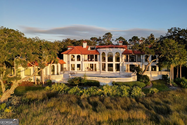 rear view of property with a patio area and a balcony