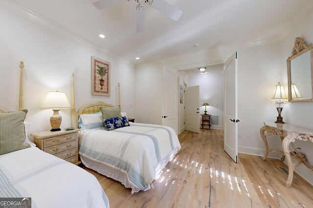 bedroom featuring crown molding, light wood-type flooring, and ceiling fan