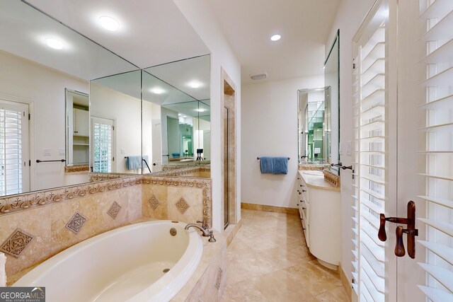 bathroom with vanity and independent shower and bath