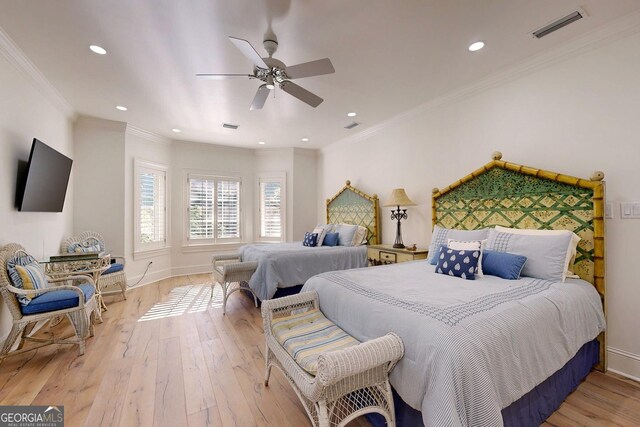 bedroom featuring light hardwood / wood-style floors, crown molding, beam ceiling, and ceiling fan