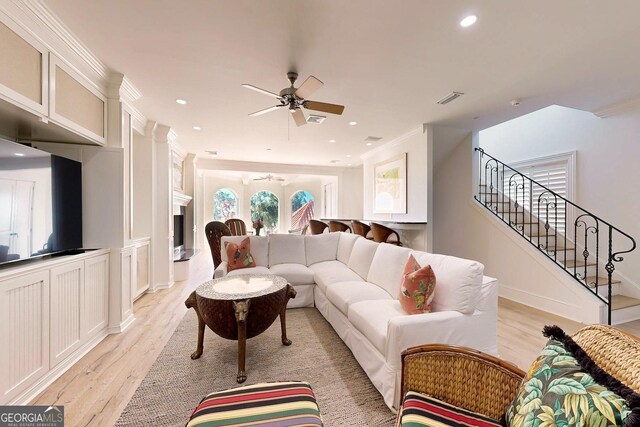 bedroom with ornamental molding, light hardwood / wood-style flooring, and ceiling fan