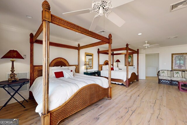 living room with ornamental molding, built in features, and light hardwood / wood-style floors