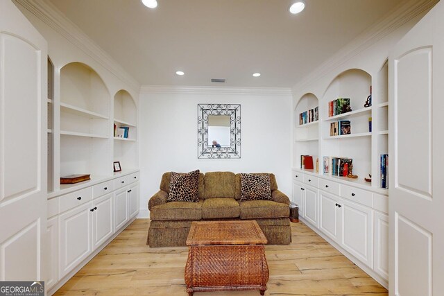 carpeted home theater featuring crown molding