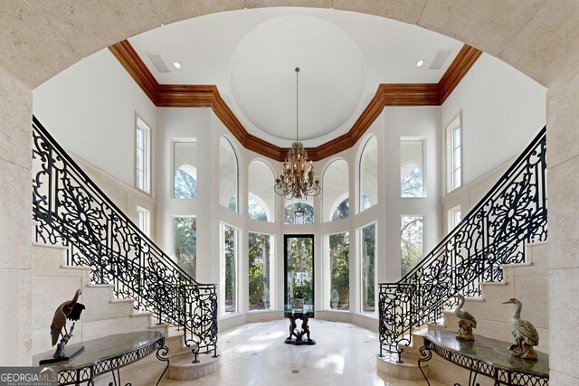 entryway with a towering ceiling and french doors