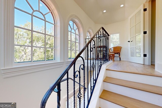 doorway featuring a water view, a healthy amount of sunlight, and ornamental molding