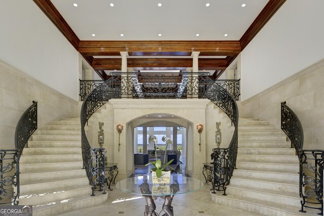 living room featuring ornamental molding and a high ceiling