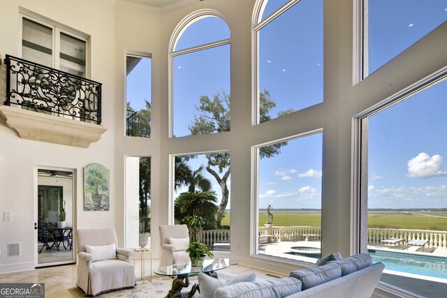 living room with beam ceiling, coffered ceiling, and a towering ceiling