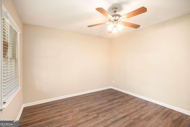 spare room featuring ceiling fan and dark hardwood / wood-style flooring