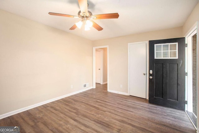 foyer with ceiling fan and wood-type flooring