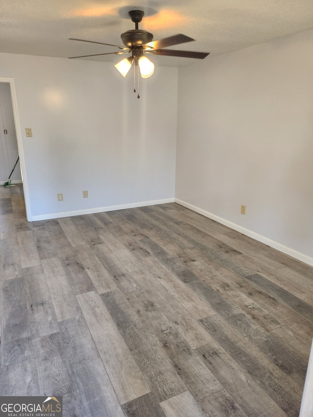 unfurnished room featuring a textured ceiling, hardwood / wood-style flooring, and ceiling fan