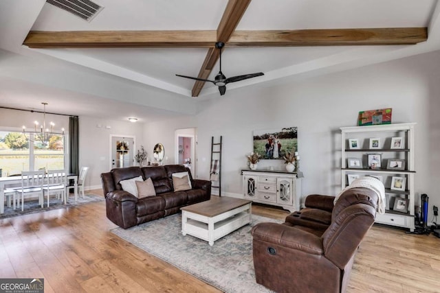 living room with light hardwood / wood-style flooring, beamed ceiling, and ceiling fan with notable chandelier