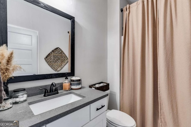 bathroom featuring toilet and vanity