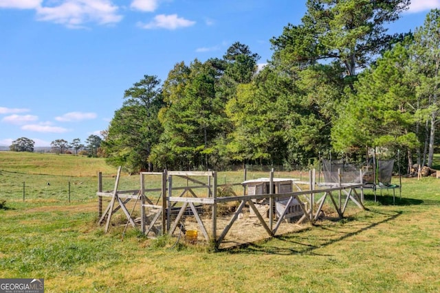 view of yard with a trampoline and a rural view