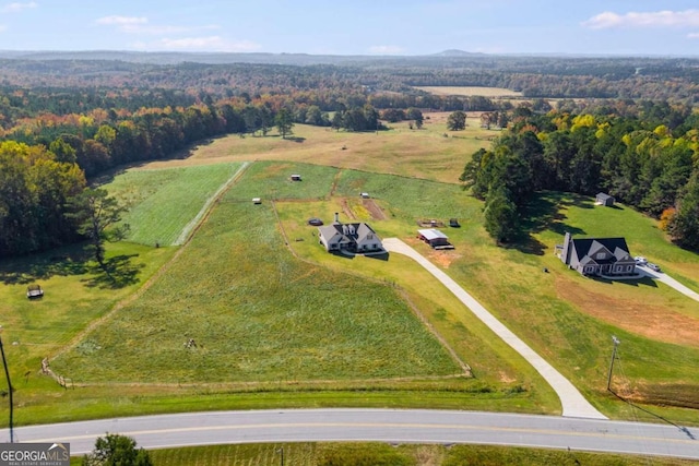 birds eye view of property with a rural view