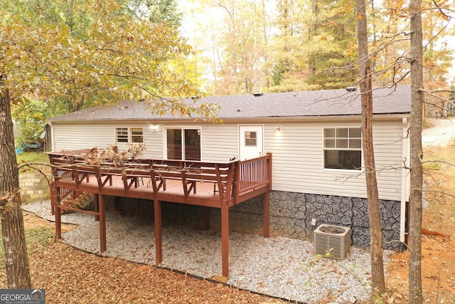 back of property with a deck and central AC unit