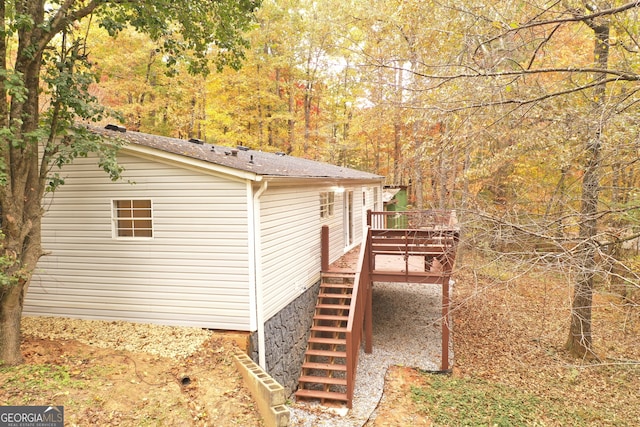 view of property exterior featuring a wooden deck