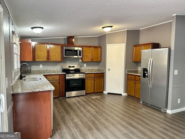 kitchen featuring ornamental molding, dark hardwood / wood-style floors, stainless steel appliances, and sink