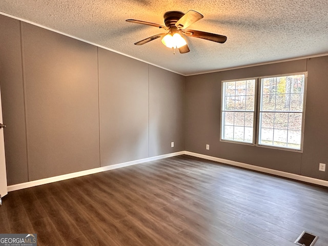 spare room with ornamental molding, ceiling fan, a textured ceiling, and dark hardwood / wood-style flooring