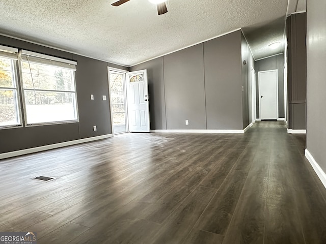 empty room with dark wood-type flooring, a textured ceiling, and ceiling fan