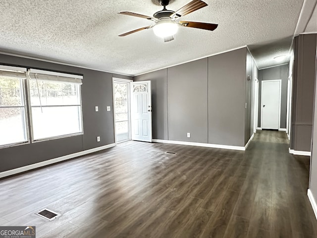 empty room featuring a textured ceiling, ceiling fan, and dark hardwood / wood-style flooring