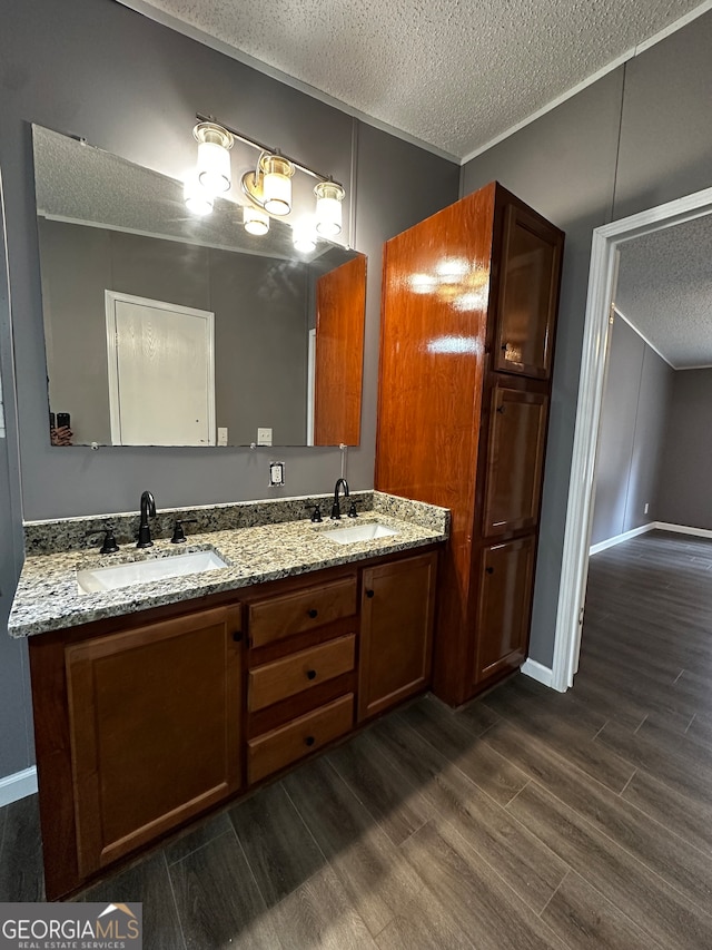 bathroom with vanity, a textured ceiling, and hardwood / wood-style floors