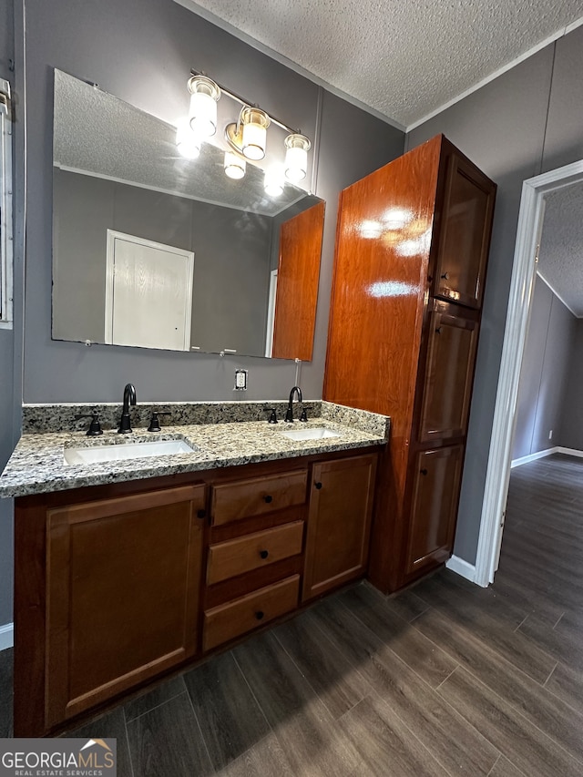 bathroom featuring vanity, hardwood / wood-style floors, and a textured ceiling