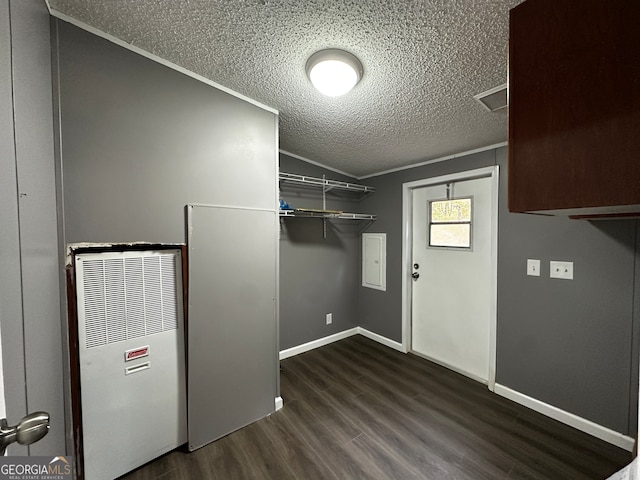 laundry area featuring ornamental molding, a textured ceiling, and dark hardwood / wood-style flooring