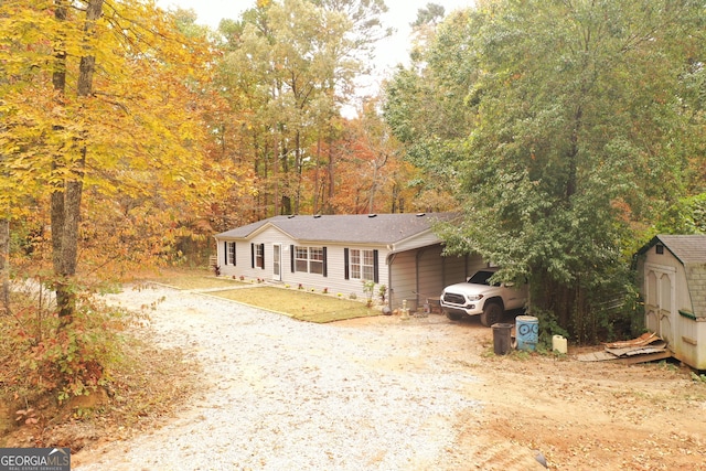 view of front facade with a garage and a shed