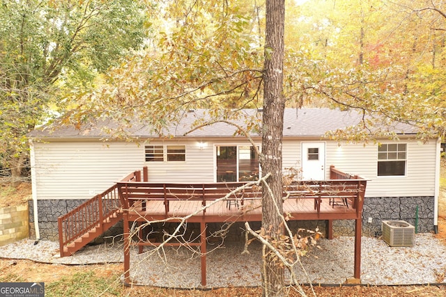 rear view of property with a deck and central air condition unit