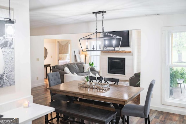 dining space featuring an inviting chandelier and dark hardwood / wood-style floors