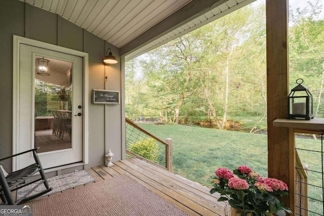 doorway to outside with lofted ceiling